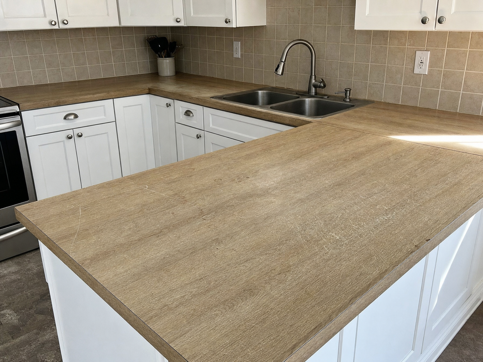 Kitchen countertops before replacement — worn surface