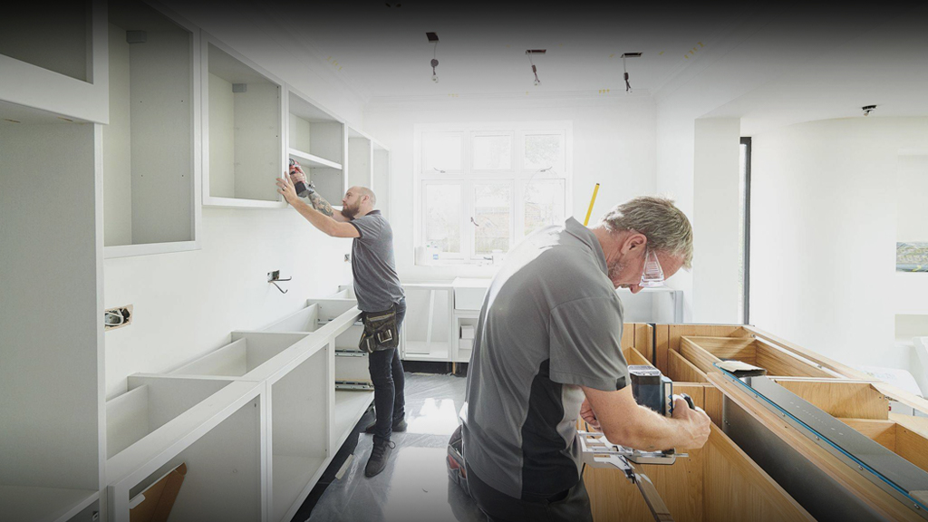Custom kitchen carpentry by Carolina Kitchens & Baths including pull-out shelves and vent hood