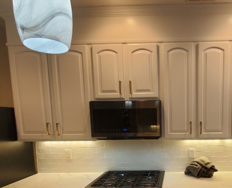 Charlotte kitchen after painting — Pure White cabinets with Cyberspace island