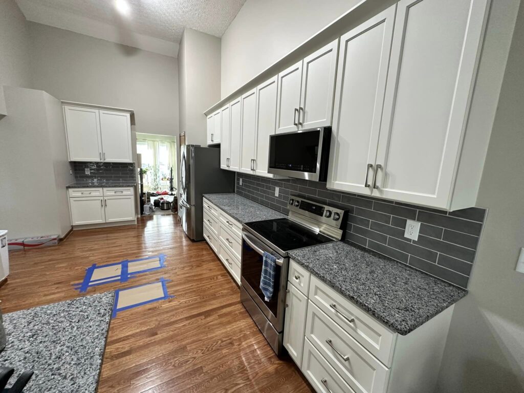 Charlotte kitchen after refacing — Snowbound beveled shaker doors